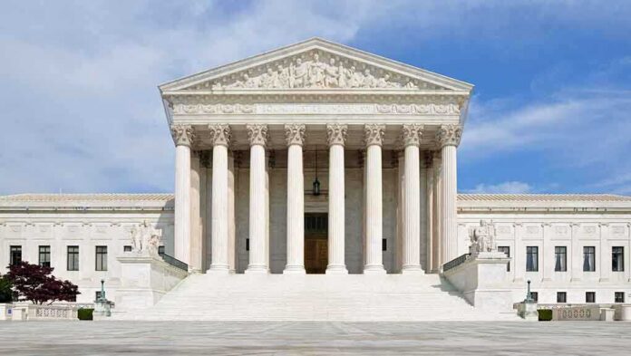 shutterstock_132568517-2 Front view of the Supreme Court building with large columns and steps under a blue sky