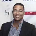 smiling man at event backdrop