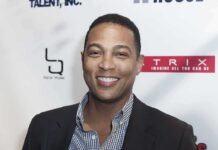 Journalism Or Crime? Lemon Case Explodes smiling man at event backdrop