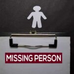 clipboard with missing person notice and paper cutout figure