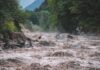 Avalanche Turns Killer Flood Flooded river gorge with fast muddy water and rocks
