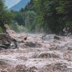 Avalanche Turns Killer Flood Flooded river gorge with fast muddy water and rocks