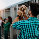 Man holding a puppy at an animal shelter