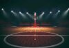 Courtline Clash Triggers SHOCK Arena Ban Basketball hoop on an empty indoor court under bright arena lights