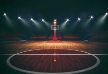 Courtline Clash Triggers SHOCK Arena Ban Basketball hoop on an empty indoor court under bright arena lights