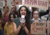 Young woman leading a protest with a megaphone