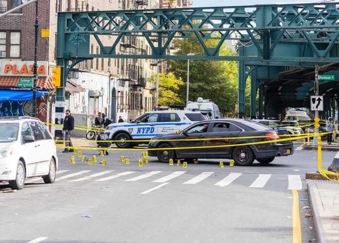shutterstock_2214792785-3 Police cars block a city intersection with yellow crime scene tape