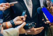 Cuban Targets Big Medicine Cartel businessperson in suit surrounded by microphones and recorders