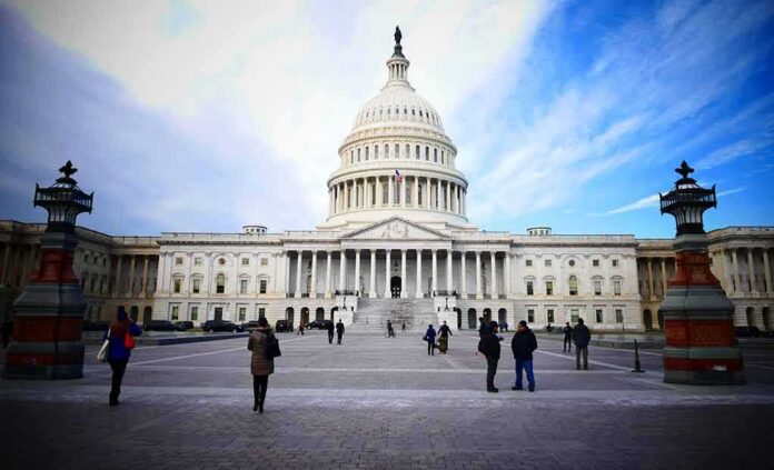 shutterstock_589919459-1 United States Capitol building with visitors on the plaza