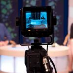 Double Entendre Wrecks Morning Show Camera focused on a television studio interview with two seated hosts