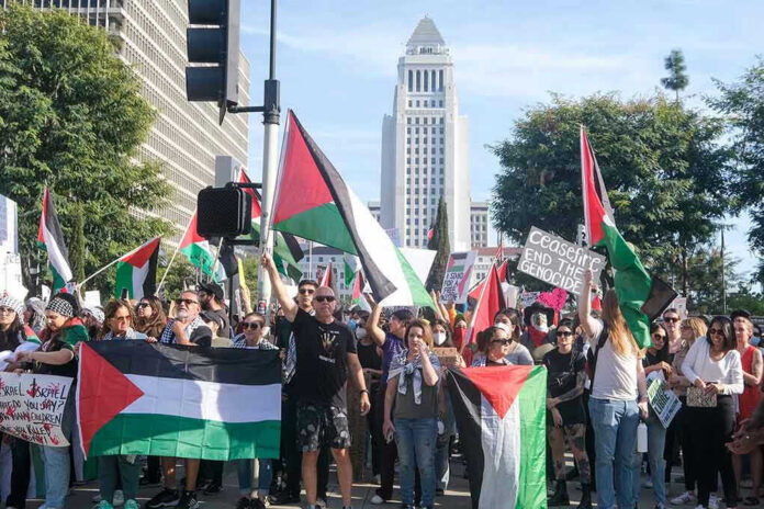 2384136043-4 Protesters holding Palestinian flags gather in a city street
