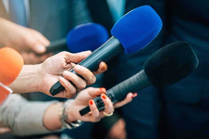 Media,Interview,Microphones,After,A,Press,Conference. Reporters holding colorful microphones