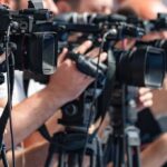 television cameras on tripods at a media event