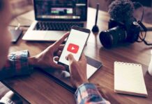 100 Practice Plays Triggered An NFL War Hands holding smartphone with video app icon at a workspace