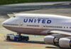 United Airlines Boeing 747 being towed on an airport taxiway