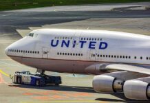 United Airlines Boeing 747 being towed on an airport taxiway