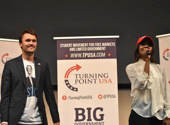 Two speakers on stage at a Turning Point USA event