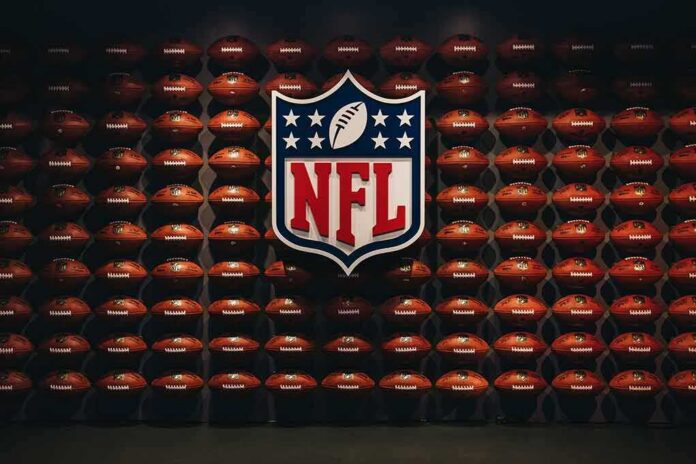 NFL shield logo over wall of footballs