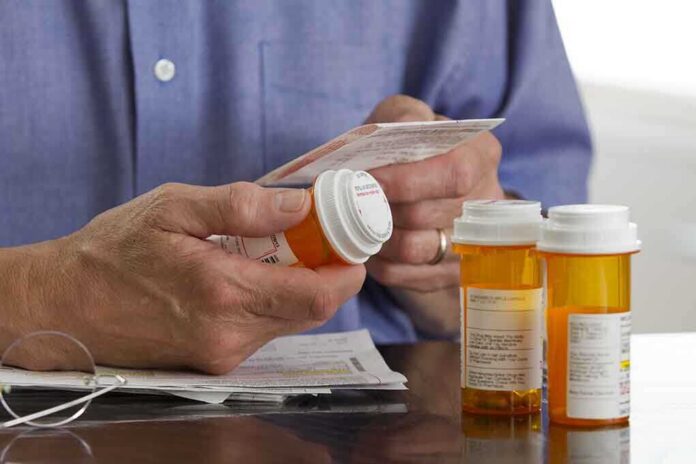 Person holding a prescription bottle and reading medical instructions