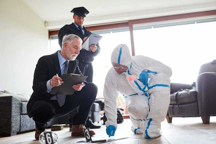 shutterstock_1455188570-1 Forensic investigator collects evidence as police and detective observe