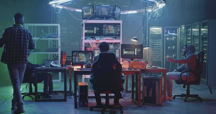 People working at computers in a dim server room
