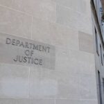 Department of Justice building exterior with American flags