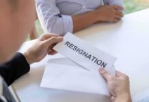 Person handing over a resignation letter in an envelope