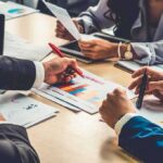business team reviewing charts at a meeting table