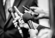 Immigration Fight Quickly Turns Personal Microphones and recorders held toward a speaker