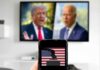 $10M Shock Wave Hits Texas Smartphone with ballot icon held before a TV showing two blurred politicians