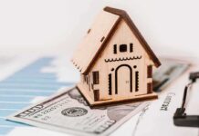 Fed Showdown: Trump Demands 1% Rates Wooden house model on money and contract papers