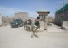 Why Violence Keeps Rising In Southeast Iran Armed soldiers patrol near a guard post outside a walled compound