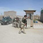Why Violence Keeps Rising In Southeast Iran Armed soldiers patrol near a guard post outside a walled compound