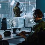 Military analysts at computers in a command center