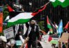 Protesters wave Palestinian flags at a city street demonstration