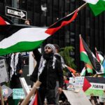 Protesters wave Palestinian flags at a city street demonstration
