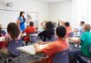 Activist Admits Years-Long Identity Deception Teacher leading classroom discussion with students raising hands