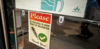 vaccination notice on a glass door