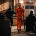 Did Prison Policy Lead to Zarutska’s Murder? Inmate in orange jumpsuit escorted by officer in courtroom