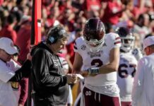 38 QBs Played As Starters Fell Mississippi State football coach and quarterback review play card on sideline