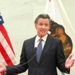 Newsom vs. Trump: Zombie Drug Showdown Gavin Newsom speaking at a podium with U.S. and California flags
