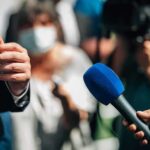 PM OUSTED: Labour Meltdown Explodes Microphones held toward a speaker at an outdoor press event