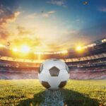 Fair Play? Croatia Win Sparks Fury Soccer ball on stadium field at sunset