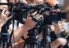 The Global Oil Market Has Bigger Forces television cameras on tripods at a media event