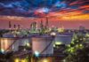 Pump Pain Twist: Trump Targets Ukraine Strikes Oil refinery with storage tanks at sunset