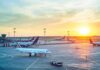 Ash Cloud Chaos Freezes Jakarta Airplanes on airport tarmac at sunset