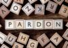 Pardon Brokers Promise Access For Millions Wooden letter blocks arranged to spell 'PARDON' on a wooden surface