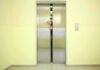 Elevator doors closing with hands reaching through the gap