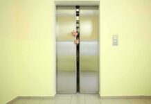 Trapped Elevator Became a Fight For Survival Elevator doors closing with hands reaching through the gap
