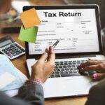 IRS Hammers OnlyFans Star Laptop displaying tax return form